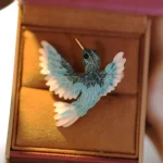Shiny blue bird brooch